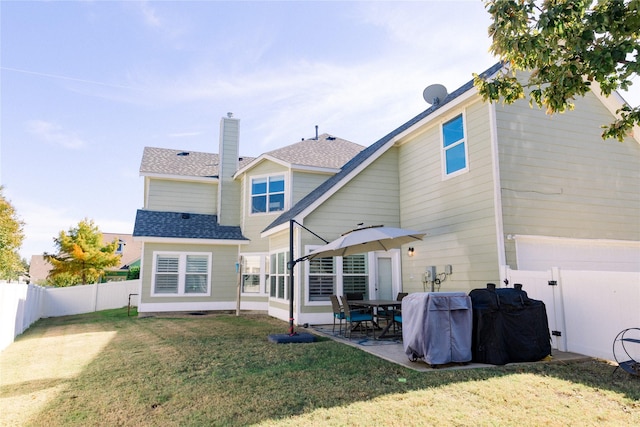 back of property featuring a patio, a yard, a fenced backyard, and a shingled roof