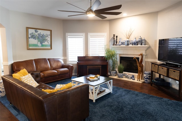 living room with ceiling fan and dark wood-type flooring