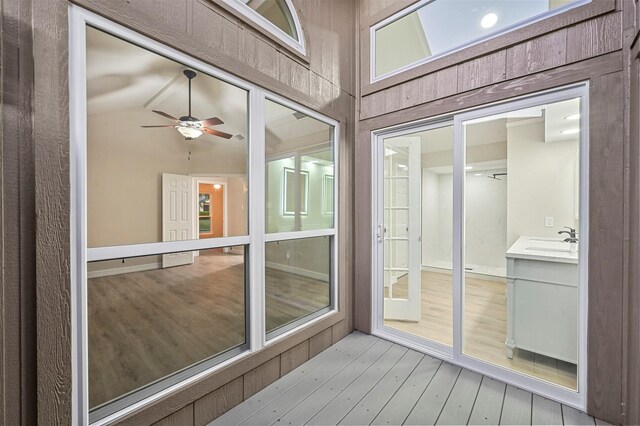 sunroom / solarium with ceiling fan, french doors, sink, and vaulted ceiling