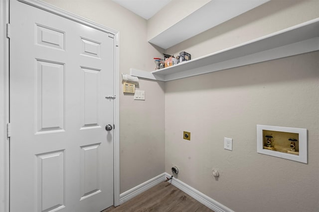 clothes washing area featuring electric dryer hookup, dark hardwood / wood-style flooring, hookup for a gas dryer, and hookup for a washing machine