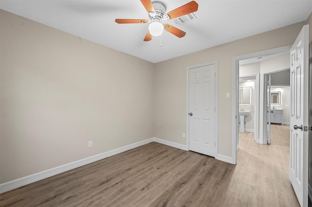 unfurnished bedroom with ceiling fan and light wood-type flooring