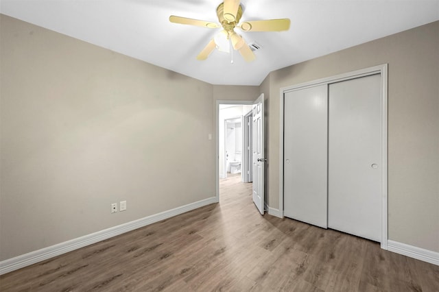 unfurnished bedroom with light wood-type flooring, a closet, and ceiling fan