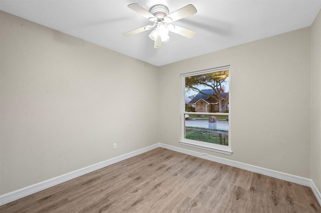 empty room with ceiling fan and light wood-type flooring