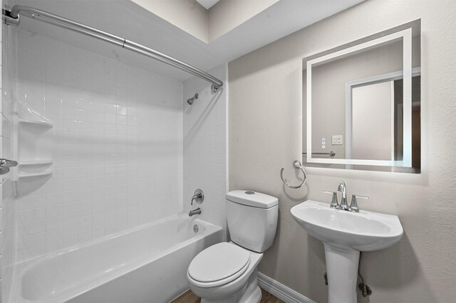 bathroom featuring bathing tub / shower combination and toilet