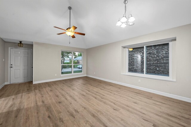 unfurnished living room with light hardwood / wood-style floors and ceiling fan with notable chandelier