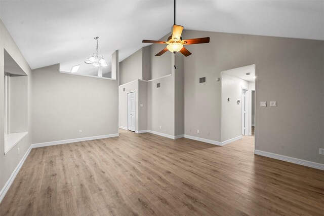 unfurnished living room with light hardwood / wood-style flooring, high vaulted ceiling, and ceiling fan with notable chandelier