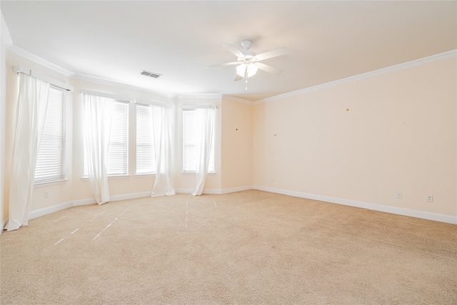 carpeted spare room with ceiling fan and ornamental molding