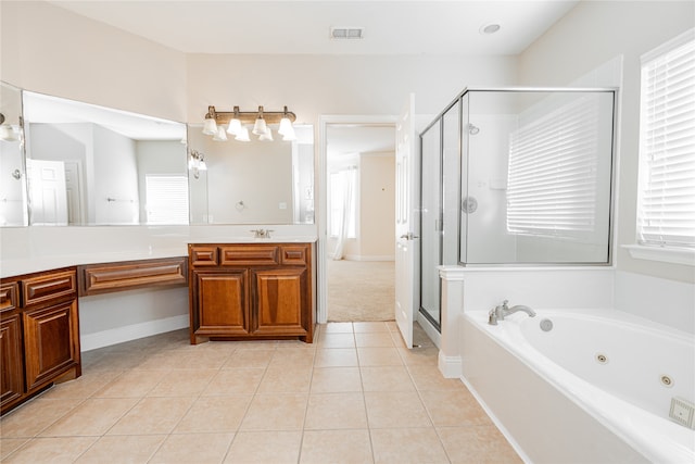 bathroom with a wealth of natural light, tile patterned flooring, and vanity