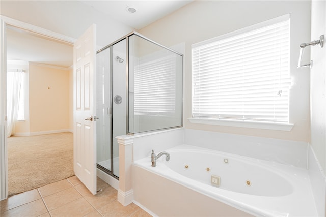 bathroom featuring tile patterned flooring, plenty of natural light, and independent shower and bath