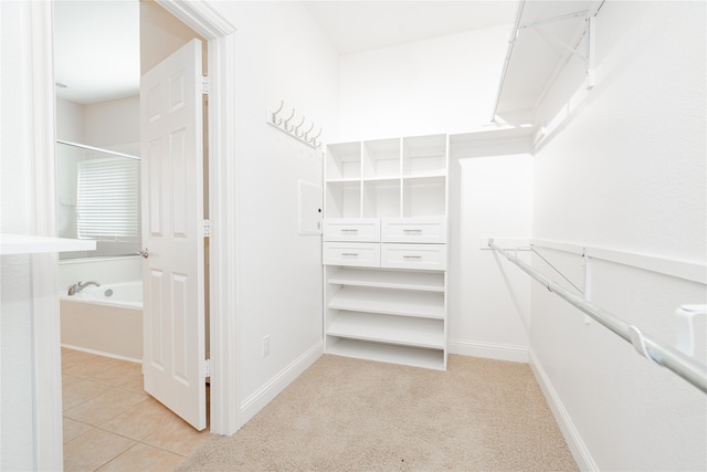 spacious closet with light tile patterned floors