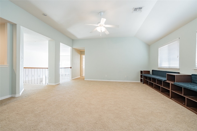 interior space featuring ceiling fan, carpet, and lofted ceiling