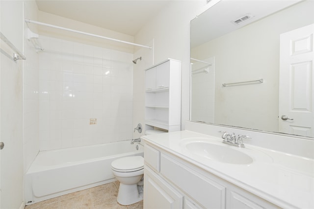 full bathroom with tile patterned flooring, tiled shower / bath combo, toilet, and vanity