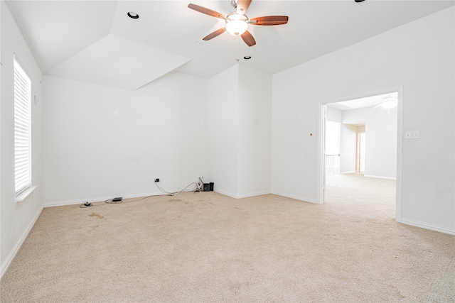 empty room featuring ceiling fan, light carpet, and lofted ceiling