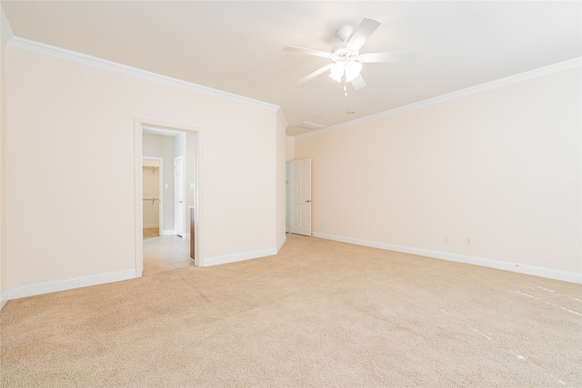 carpeted spare room with ceiling fan and ornamental molding