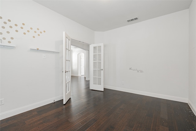 unfurnished room featuring french doors and dark hardwood / wood-style flooring