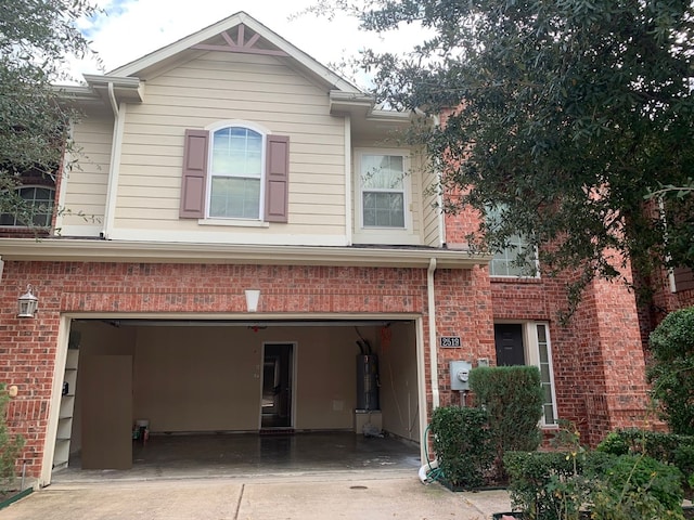 rear view of house featuring water heater and a garage