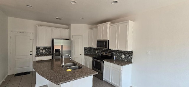 kitchen featuring appliances with stainless steel finishes, an island with sink, sink, white cabinets, and light tile patterned floors