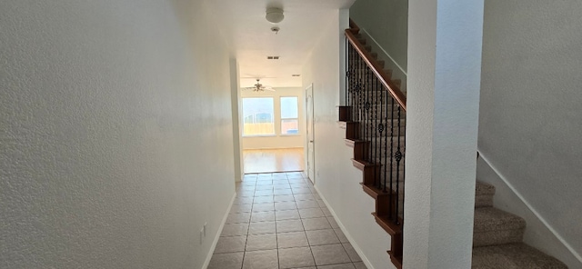 hall with light tile patterned floors