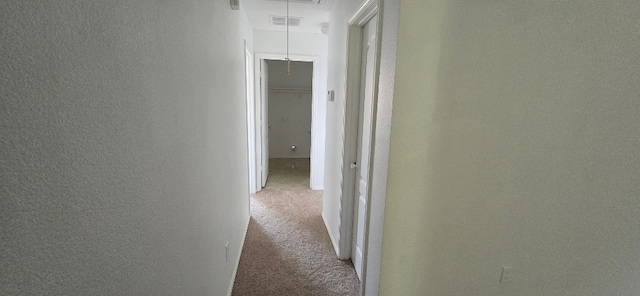 hallway featuring light carpet