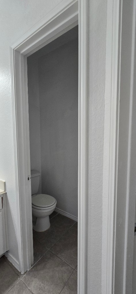 bathroom featuring vanity, tile patterned floors, and toilet