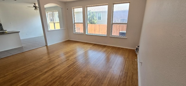 spare room featuring hardwood / wood-style flooring and ceiling fan