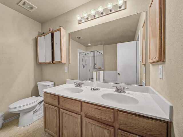 bathroom with toilet, vanity, and walk in shower