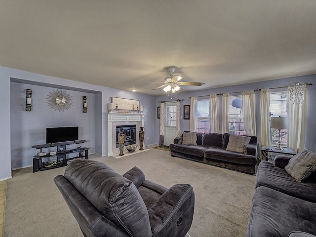 living room featuring light carpet, a fireplace, and ceiling fan