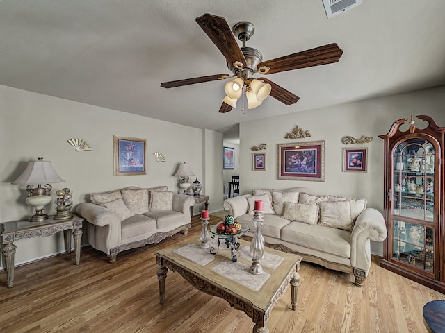 living room featuring ceiling fan and wood-type flooring