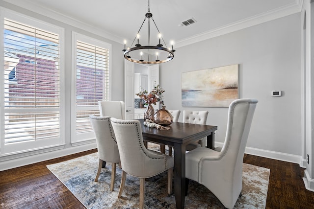 dining room with crown molding, a chandelier, and dark hardwood / wood-style floors