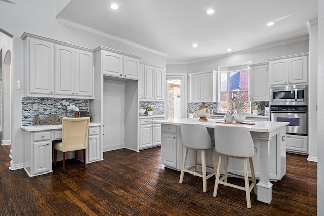 kitchen with white cabinetry, a center island, and stainless steel appliances