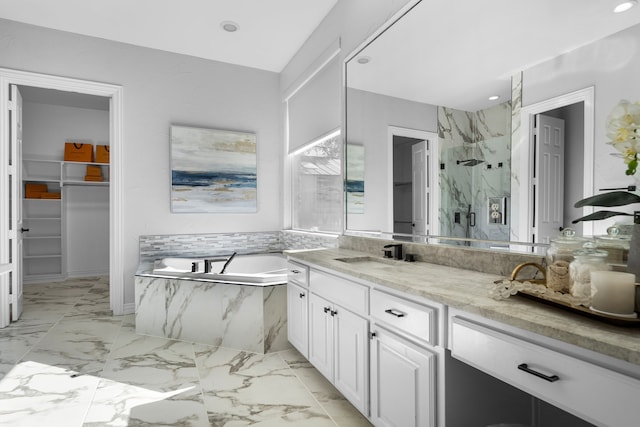 bathroom with vanity and separate shower and tub