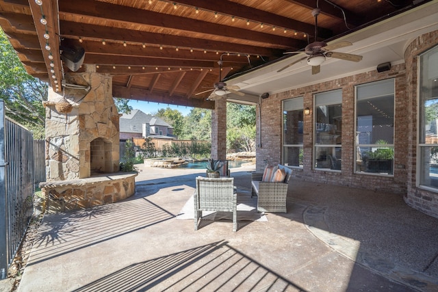 view of patio / terrace with an outdoor stone fireplace and ceiling fan