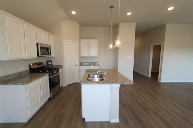 kitchen featuring white cabinets, appliances with stainless steel finishes, decorative light fixtures, a kitchen island with sink, and a sink