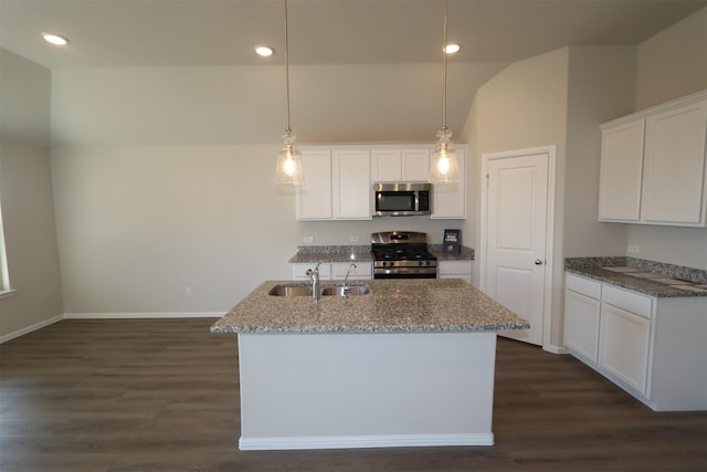 kitchen featuring stainless steel appliances, white cabinets, a sink, and hanging light fixtures