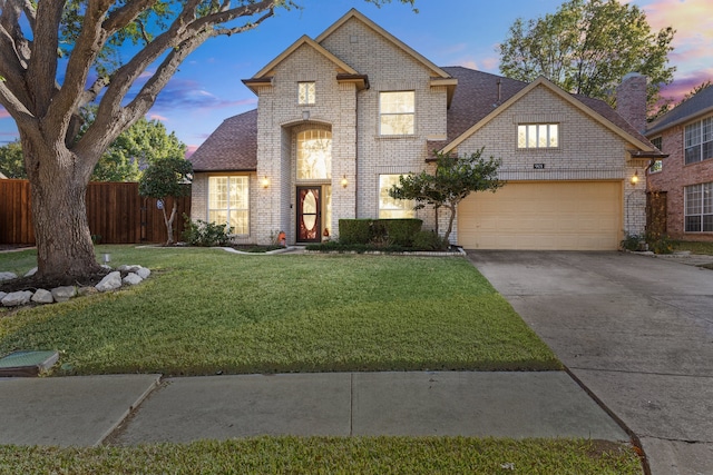 view of front of home featuring a yard and a garage