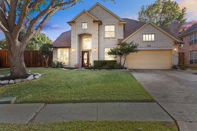 traditional-style house featuring a front yard, brick siding, fence, and driveway