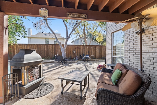 view of patio with an outdoor living space with a fireplace