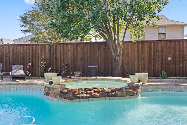 view of pool with an in ground hot tub