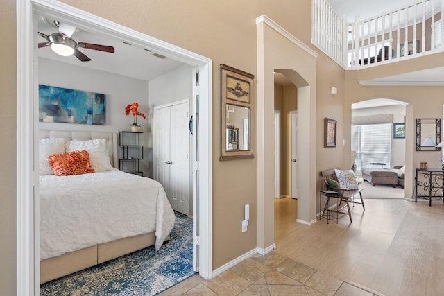 bedroom with ceiling fan, light hardwood / wood-style flooring, and a closet