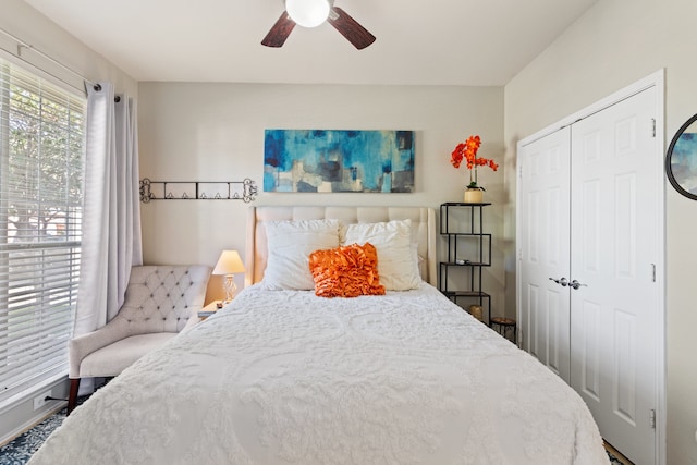 bedroom with ceiling fan and a closet