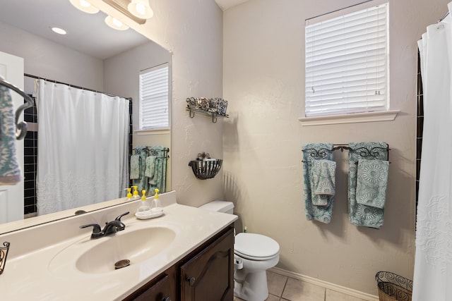 bathroom featuring tile patterned floors, vanity, and toilet