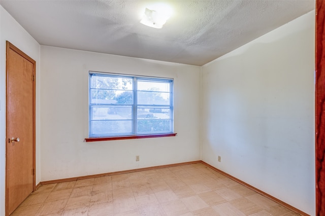 empty room with a textured ceiling