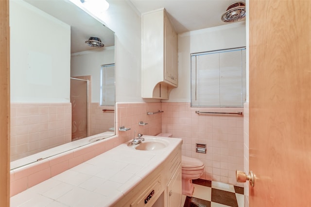 bathroom featuring walk in shower, vanity, tile walls, and toilet