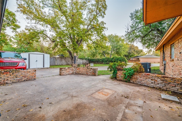 view of patio with a storage unit