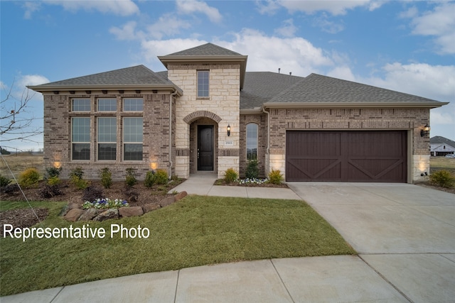 view of front of home featuring a front yard and a garage