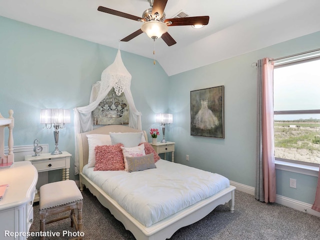 carpeted bedroom with vaulted ceiling and ceiling fan