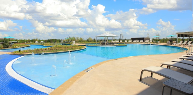 view of pool with a patio and pool water feature