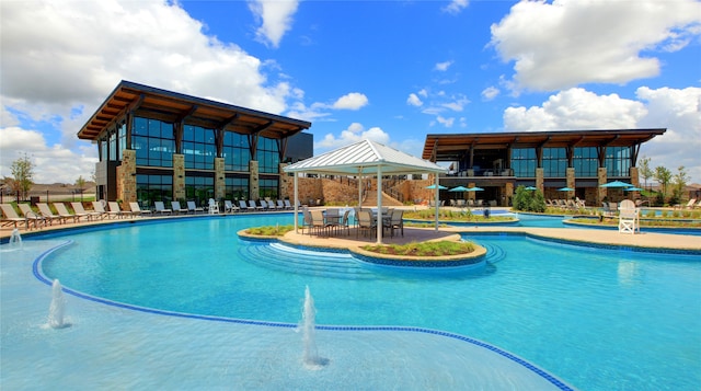 view of swimming pool with pool water feature and a patio