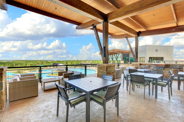 view of patio / terrace with area for grilling, outdoor lounge area, and exterior kitchen