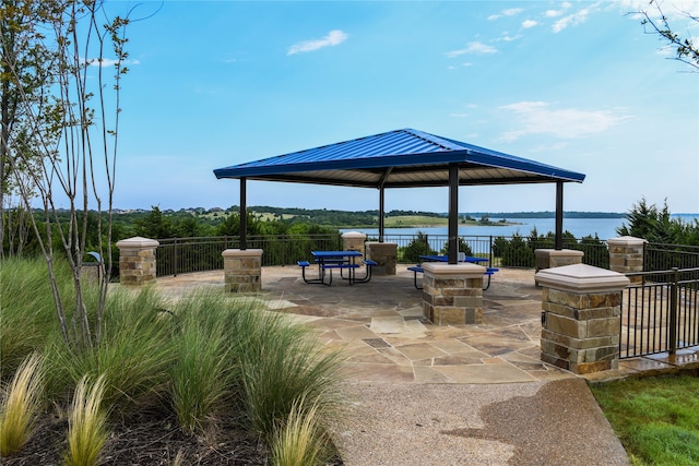 view of patio / terrace featuring a gazebo and a water view